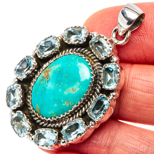 Turquoise and blue topaz pendant in silver bezel with round bail, stone-framed halo.