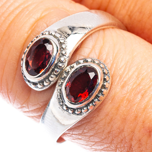 Sterling silver ring with two oval garnet-red stones in ornate bezel setting