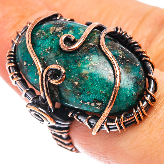 Turquoise cabochon wire wrap ring with oxidized copper oval frame and dark coil band