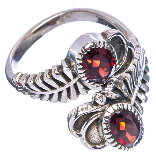 Sterling silver adjustable ring with oval faceted red stones and ornate side scrolls