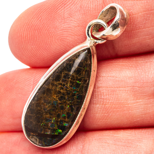 Ammolite pendant in teardrop setting with iridescent black, green, and blue stone