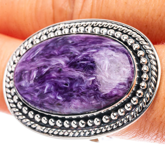 Oval purple charoite cabochon ring in .925 sterling silver bezel, detailed silver frame