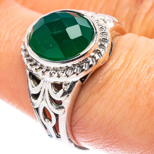 Sterling silver ring with green faceted gemstone and ornate filigree setting