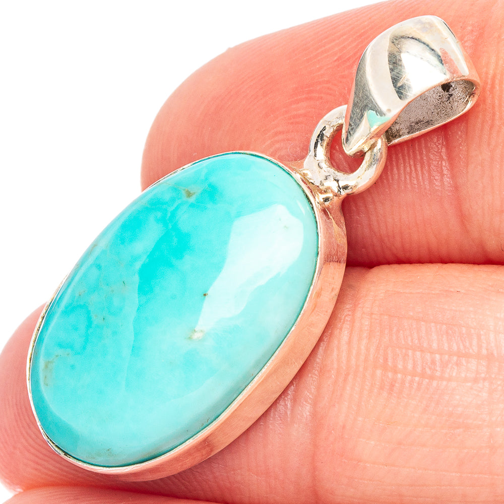 Oval turquoise stone pendant with sterling silver bezel and hanging loop