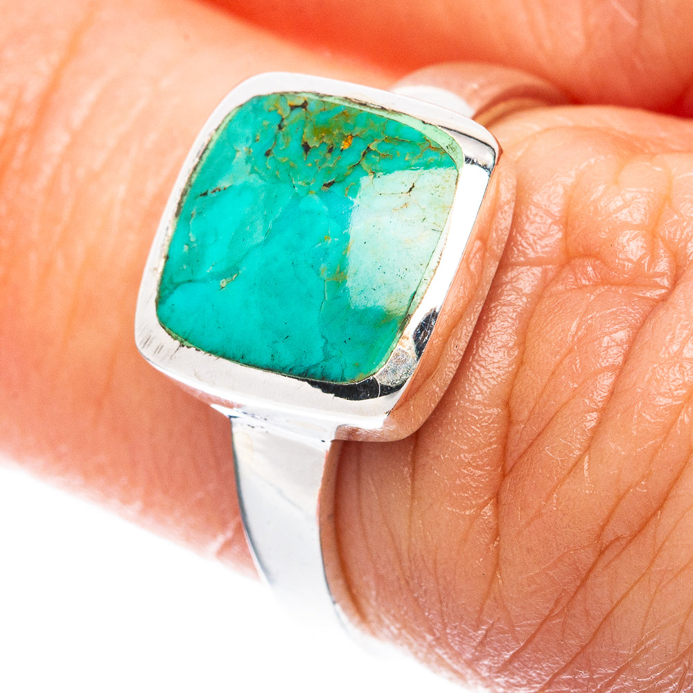 Sterling silver ring with square bezel-set turquoise cabochon on fingertip