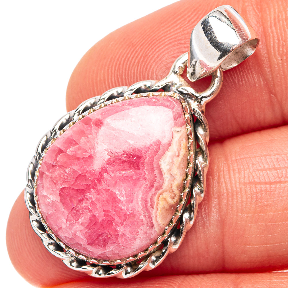 Pink rhodochrosite oval pendant in .925 sterling silver bezel with prong bail