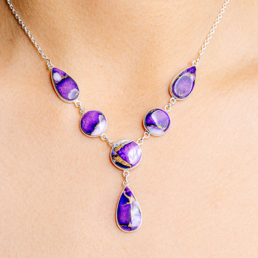 Sterling silver necklace with five purple teardrop gemstone charms on a chain
