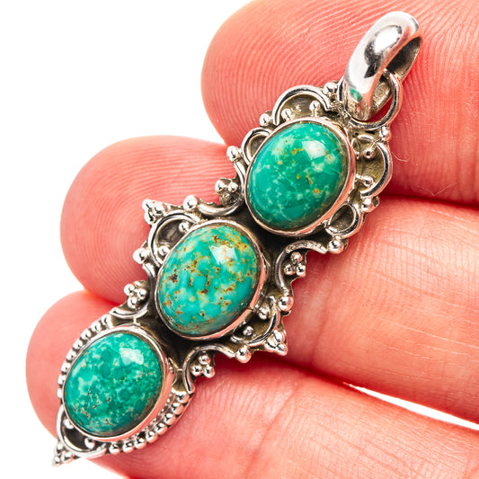 Sterling silver turquoise pendant with three oval cabochon stones, ornate bezel