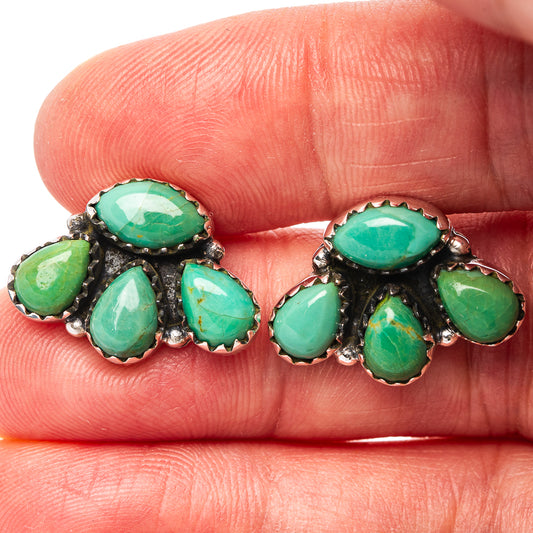 Close-up turquoise cluster earrings with green oval stones and scalloped sterling silver rims.