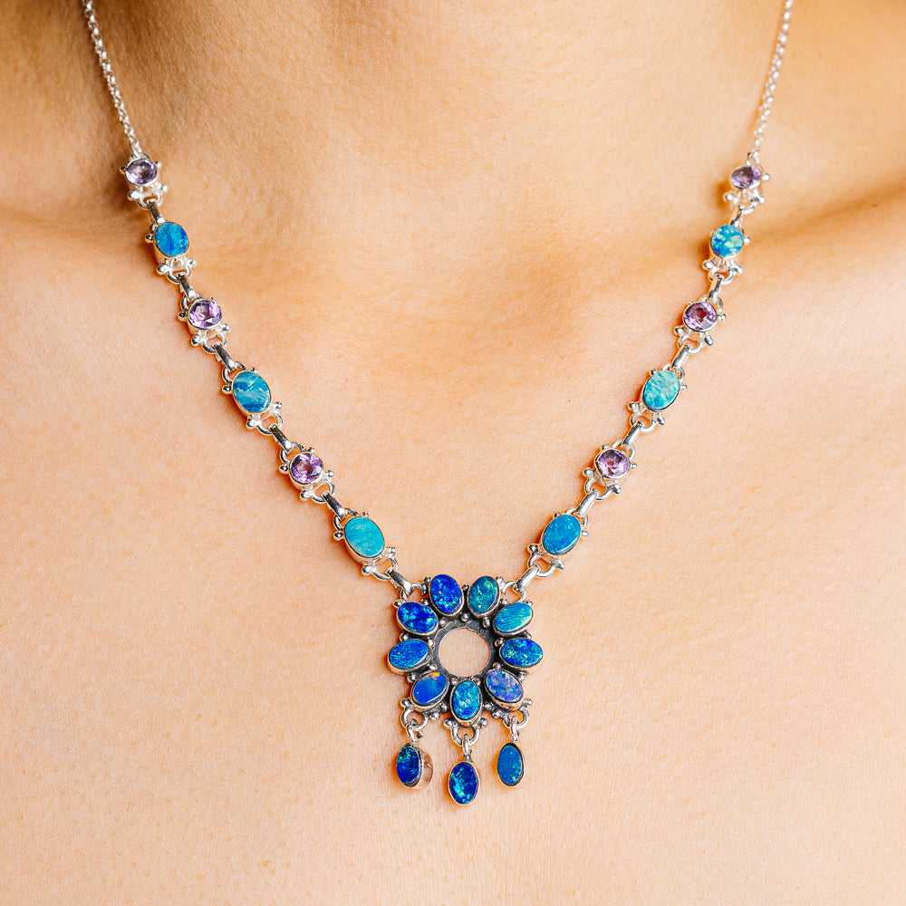 Sterling silver necklace with blue turquoise and purple gemstone cluster pendant