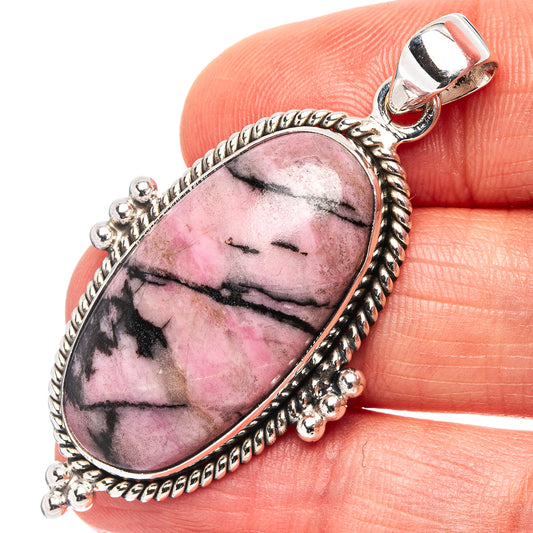 Oval rhodonite pendant with .925 sterling silver bezel and bail, black-veined pink stone