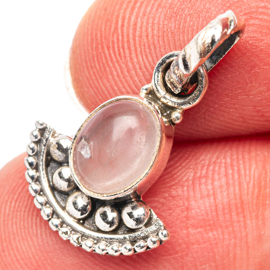 Sterling silver rose quartz pendant with ornate crescent setting and oval pink stone
