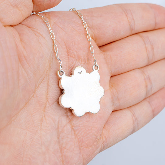 Sterling silver flower-shaped pendant necklace on a chain with stamped details