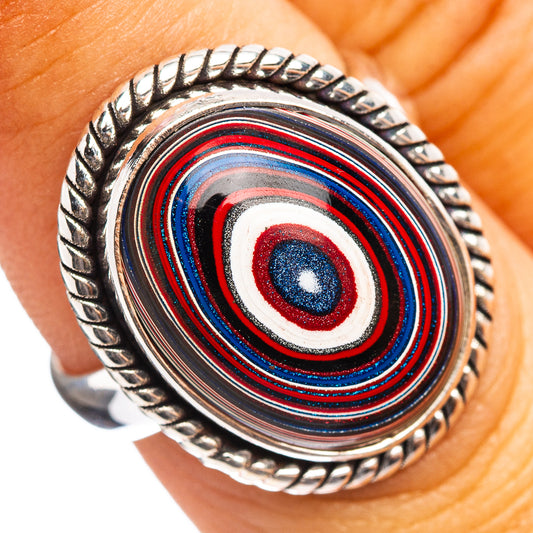 Sterling silver ring on finger, oval concentric red/blue/white inlay bezel