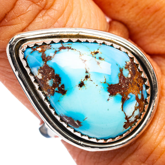 Turquoise cabochon silver-tone ring with ornate bezel and serrated edge