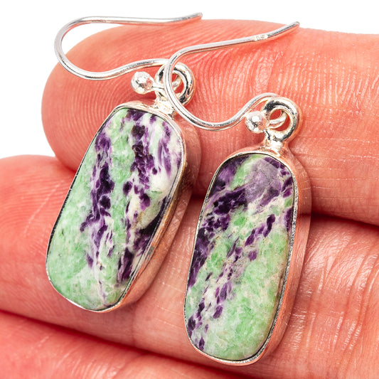 Close-up of sterling silver dangle earrings with oval mottled purple-green stones