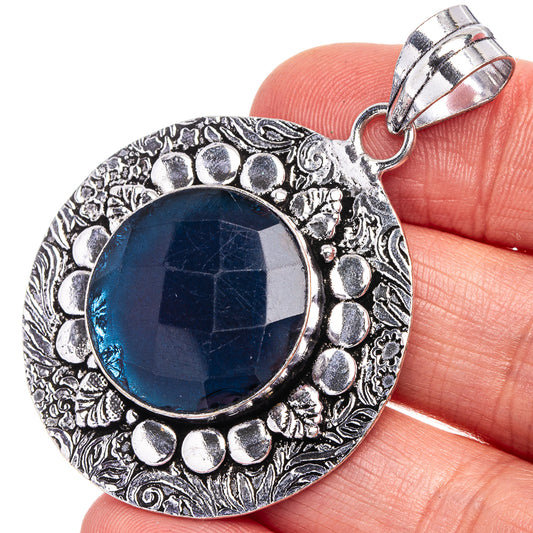 Blue quartz round pendant with ornate silver-tone bezel and top bail, close-up