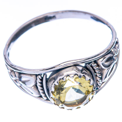 Sterling silver citrine ring with round faceted yellow center and scrolling side setting