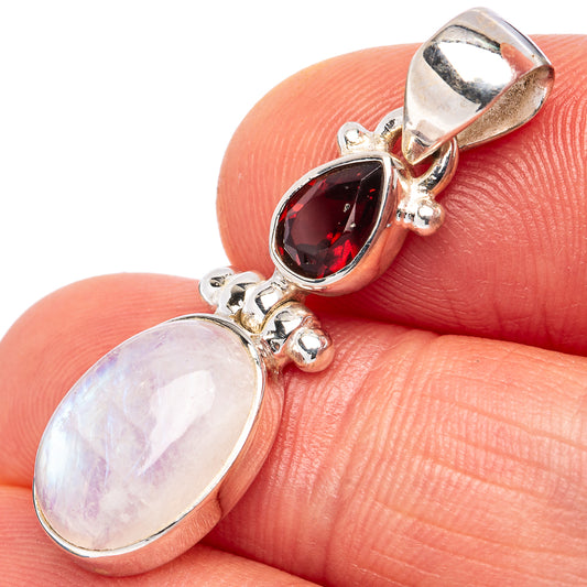 Sterling silver pendant with oval red garnet and opalescent moonstone cabochon