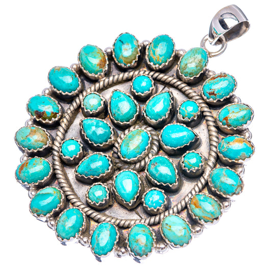 Round turquoise pendant with intricate silver rosette frame and top bail loop