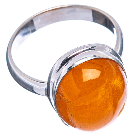 Sterling silver ring with orange amber cabochon, oval face and rounded band