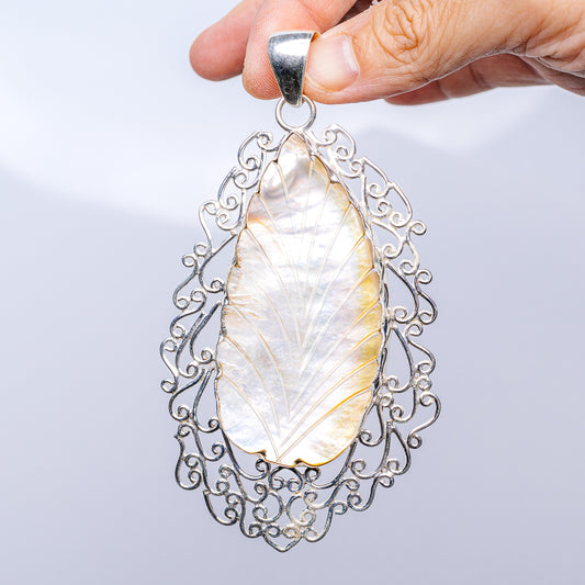 Teardrop mother of pearl pendant with ornate .925 sterling silver filigree setting