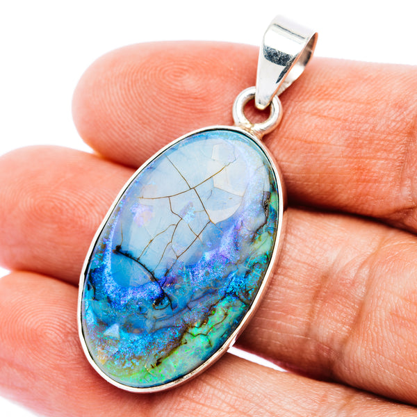 Oval .925 sterling silver opal pendant with blue-green iridescent gemstone center
