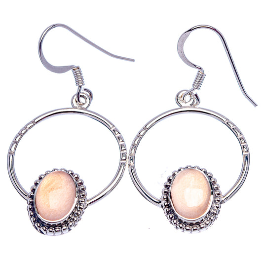 Sterling silver fishhook earrings with peach oval moonstone and beaded halo within hoop