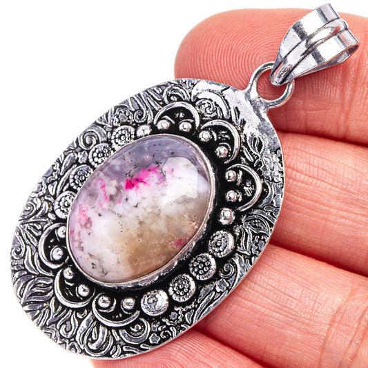 Oval pink dendritic opal pendant in ornate German silver setting, loop bail