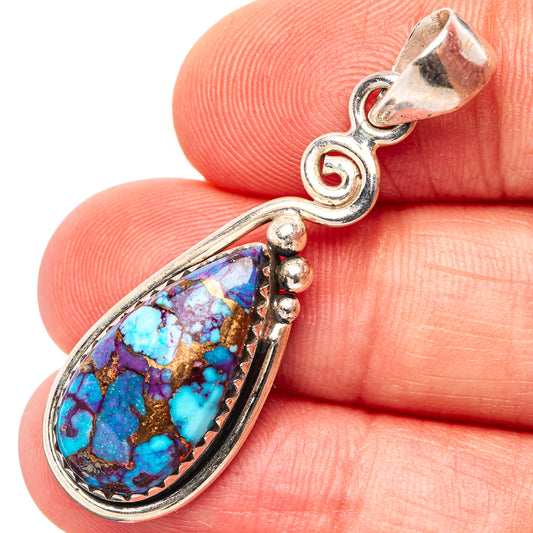 Sterling silver pendant with teardrop turquoise cabochon and swirled bezel setting