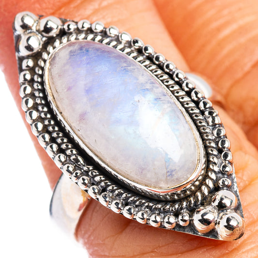 Sterling silver moonstone ring with oval opalescent stone and beaded halo setting