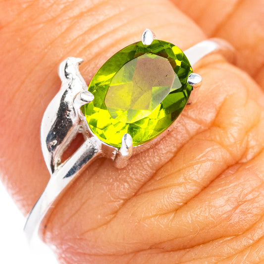 Sterling silver bird ring with oval green peridot-style gemstone, prong-set
