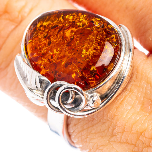 Oval amber cabochon bezel in .925 sterling silver ring, detailed setting