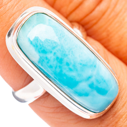 Sterling silver Larimar oval ring with light blue stone, close-up on hand