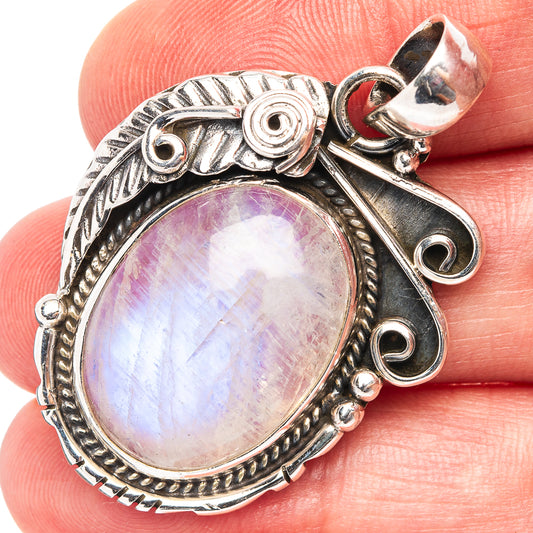 Oval rainbow moonstone pendant in .925 sterling silver, ornate bezel and bail