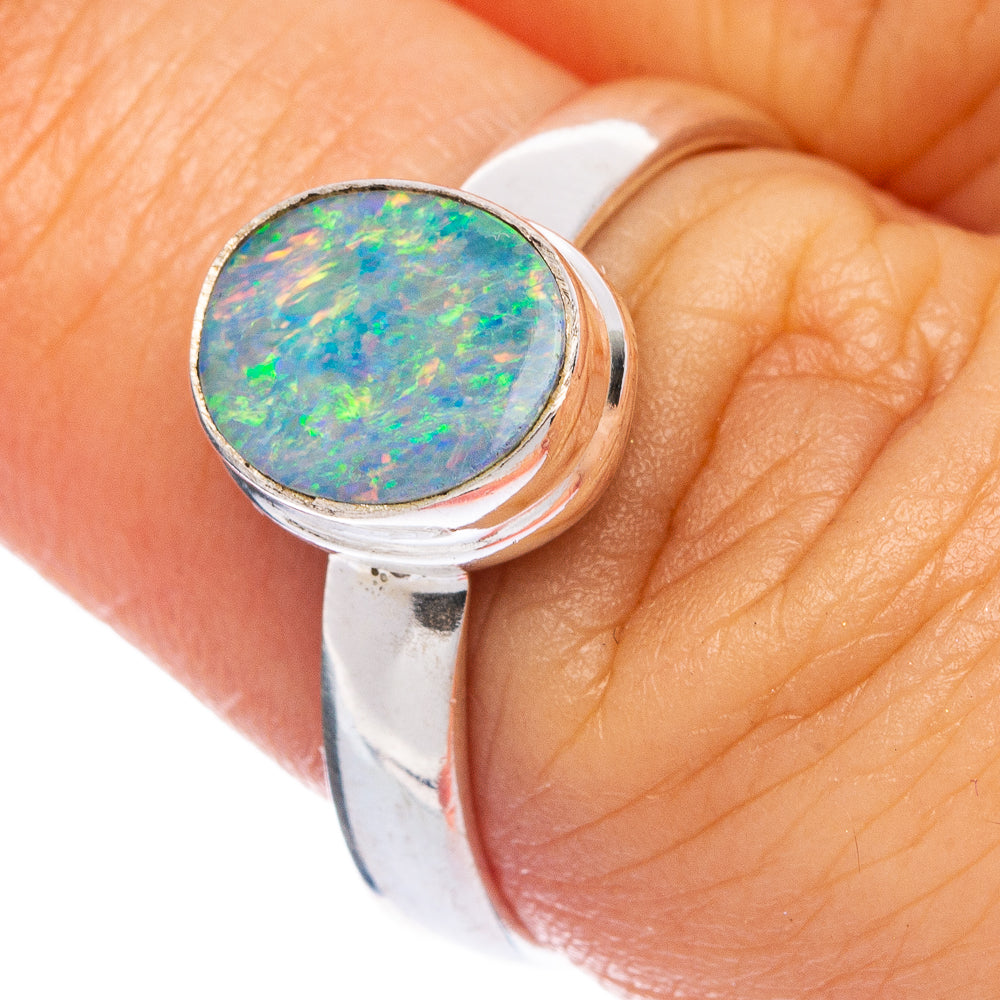 Oval blue-green opal cabochon ring in 925 sterling silver on finger