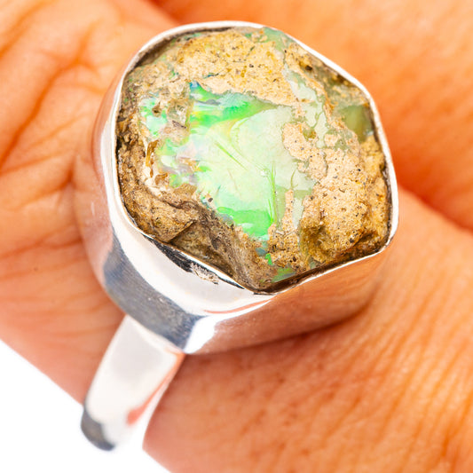 Sterling silver raw opal ring, green-orange rock-like stone bezel, top view