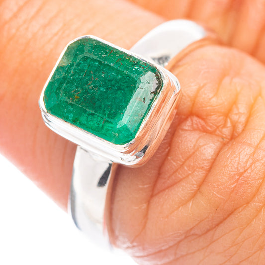 Faceted green emerald ring with polished sterling silver band and square bezel setting