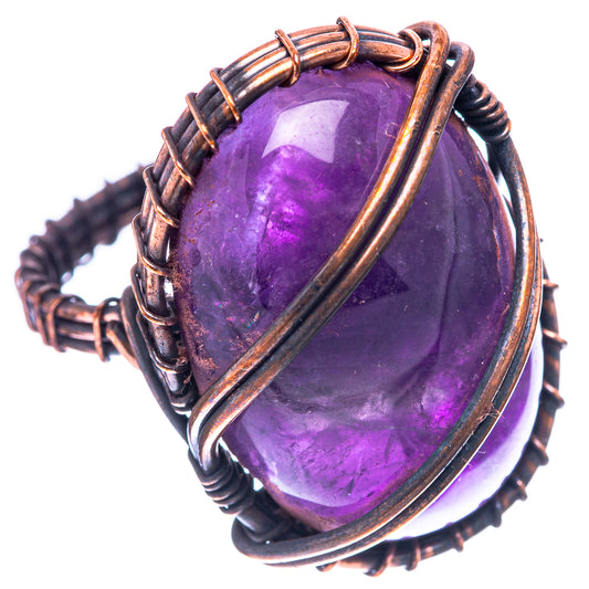 Amethyst oval wire wrap ring with oxidized copper frame, purple stone close-up