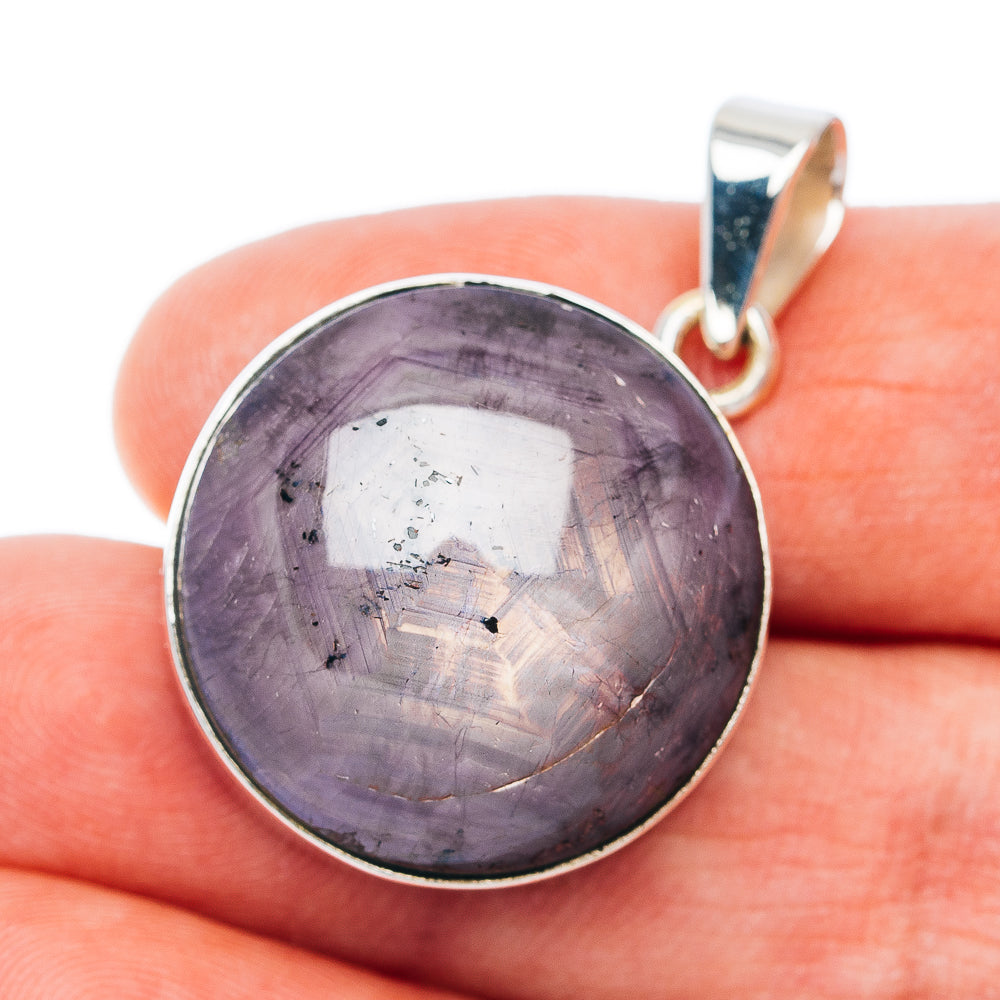 Sterling silver round gemstone pendant with dark purple cabochon
