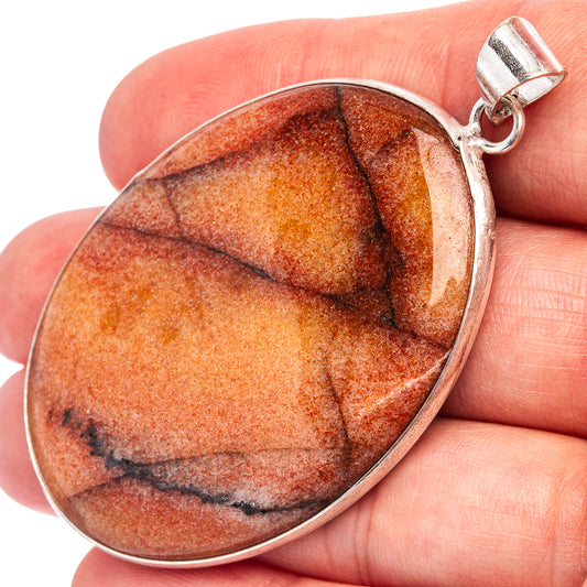 Silver-plated oval sunstone pendant with red-orange stone and dark bands