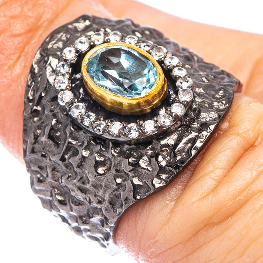 Black rhodium plated sterling silver ring with blue topaz center and diamond halo