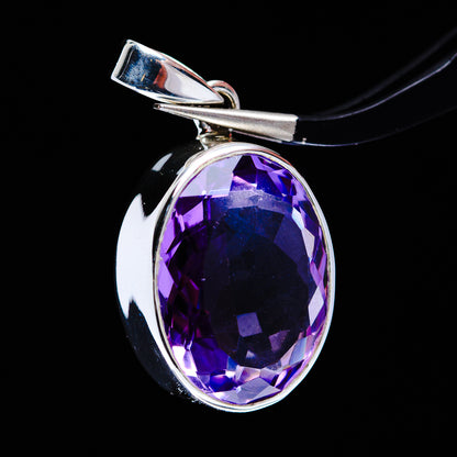 Sterling silver bezel-set oval amethyst pendant with bail, side view