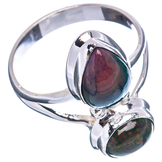 Sterling silver ring with raised teardrop opal stones; one shows purple with green flecks.