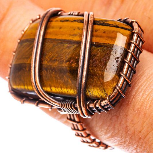 Amber tiger's eye ring with oxidized copper wire frame, side close-up