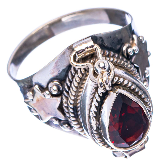Sterling silver ring with red teardrop garnet, shield setting, and carved rope bands