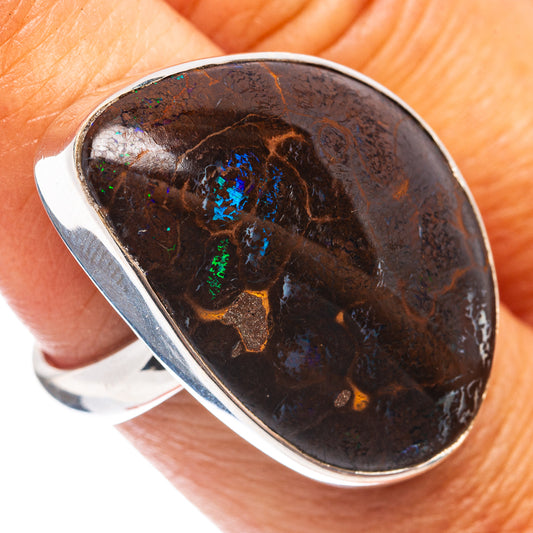 Oval boulder opal set in sterling silver ring, dark brown stone with vivid blue light