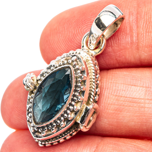 Sterling silver pendant with oval blue gemstone and ornate beaded halo