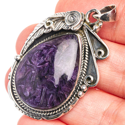 Sterling silver charoite pendant with teardrop purple stone and ornate bezel detail