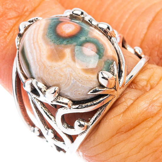 Ocean jasper cabochon sterling silver ring with ornate claw prongs, oval stone